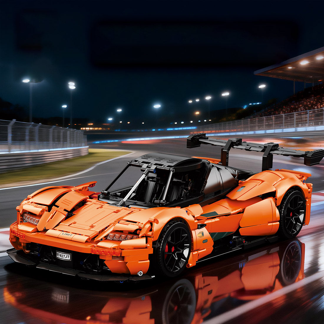 Orange sports car model on a racetrack at night